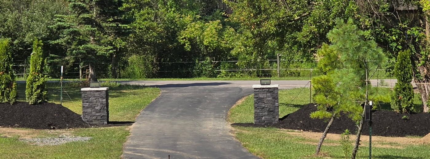 Frame your driveway with Iron Ore faux stone columns that add definition, contrast, and long-lasting curb appeal using GenStone panels.