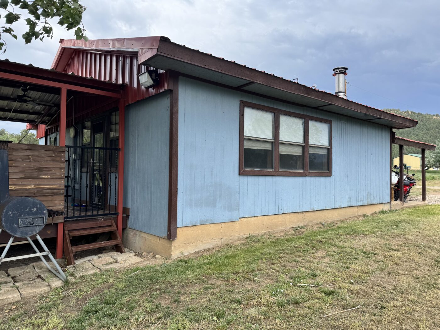 A home before its new siding exterior was created using GenStone's Desert Sunrise Stacked Stone panels.