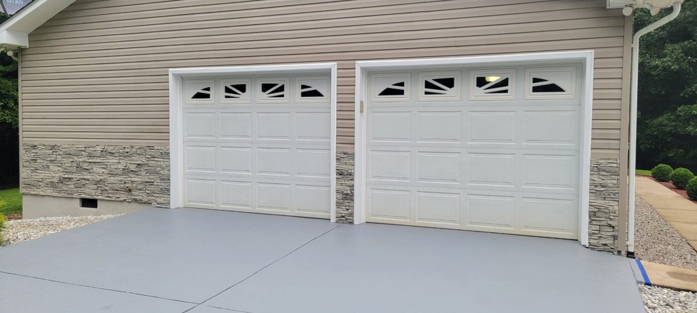 Enhance your home’s exterior with Arctic Smoke stone wainscoting, adding subtle texture and a cohesive, finished look across siding and garage.