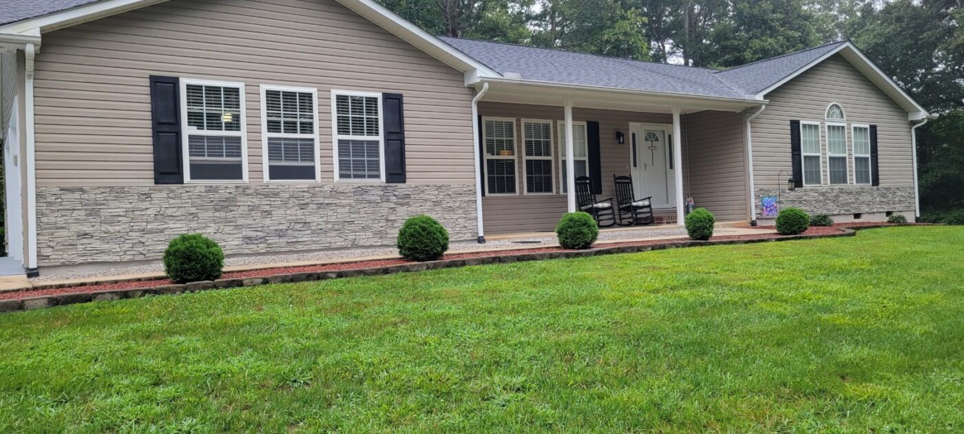 Enhance your home’s exterior with Arctic Smoke stone wainscoting, adding subtle texture and a cohesive, finished look across siding and garage.