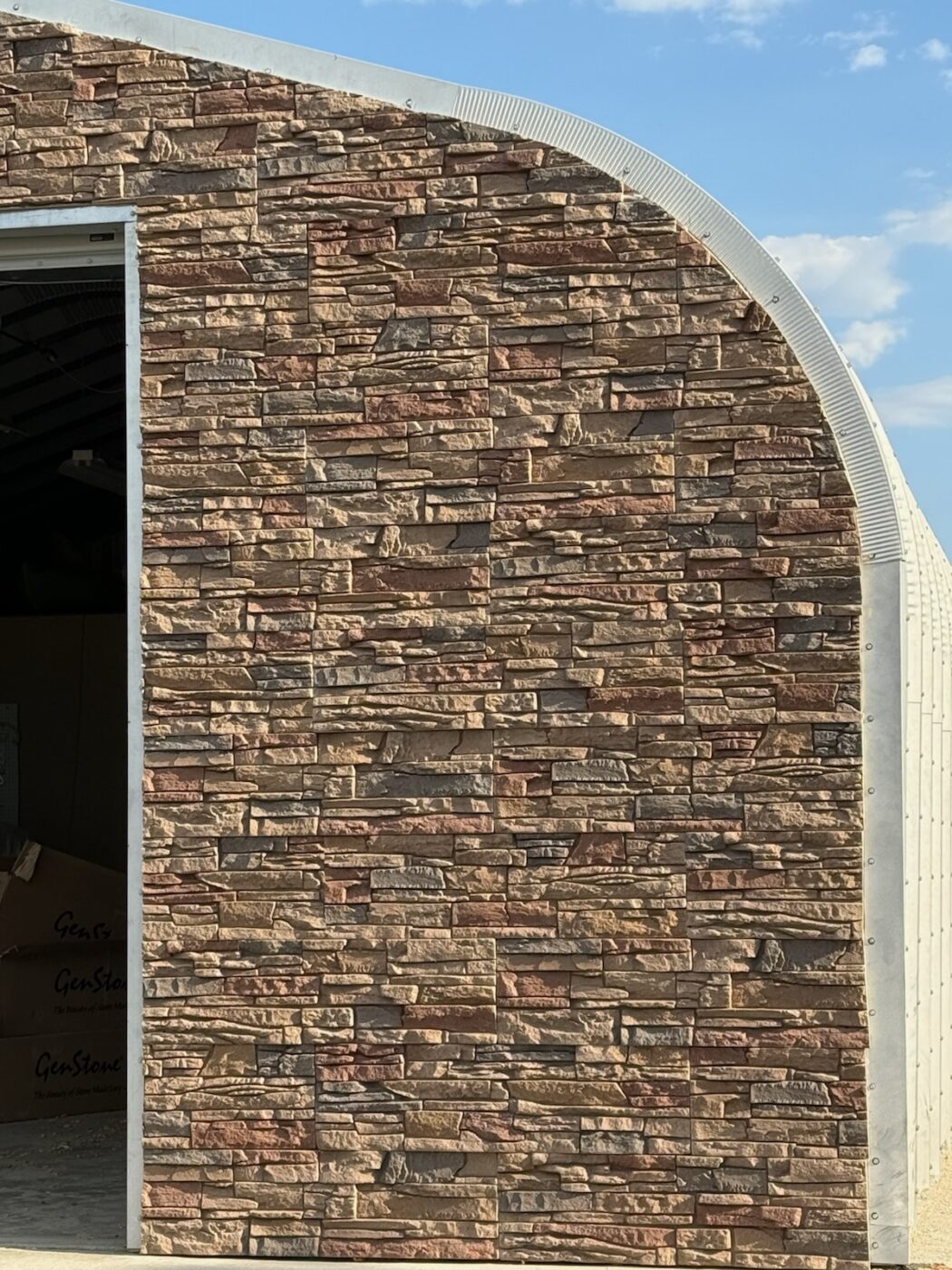This garage's exterior siding was upgraded with GenStone's Desert Sunrise Stacked Stone panels.