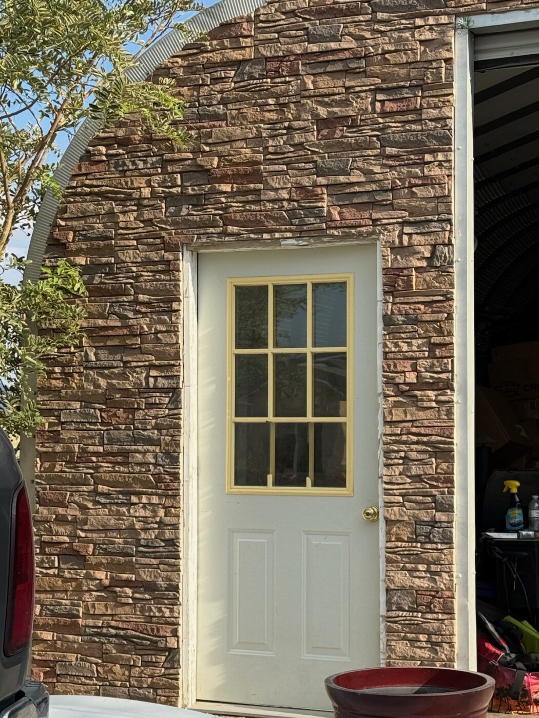 This garage's exterior siding was upgraded with GenStone's Desert Sunrise Stacked Stone panels.