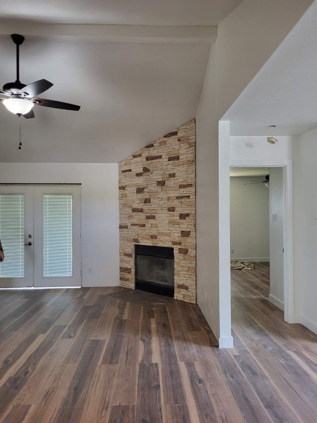 A fireplace surround designed using GenStone's Vanilla Bean Stacked Stone panels.